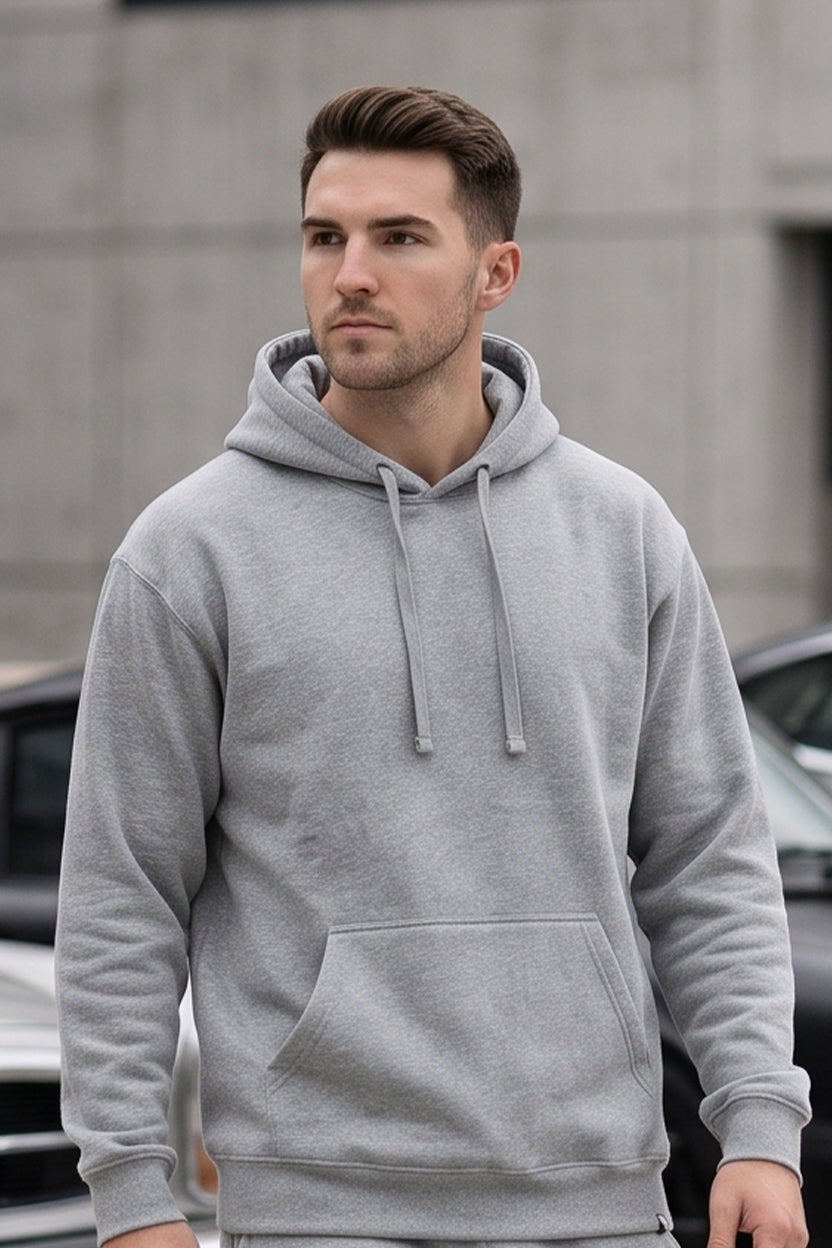 Man wearing a light gray wholesale fleece pullover hoodie from S&S Textile and Apparel Inc., outdoor lifestyle photo, mobile view