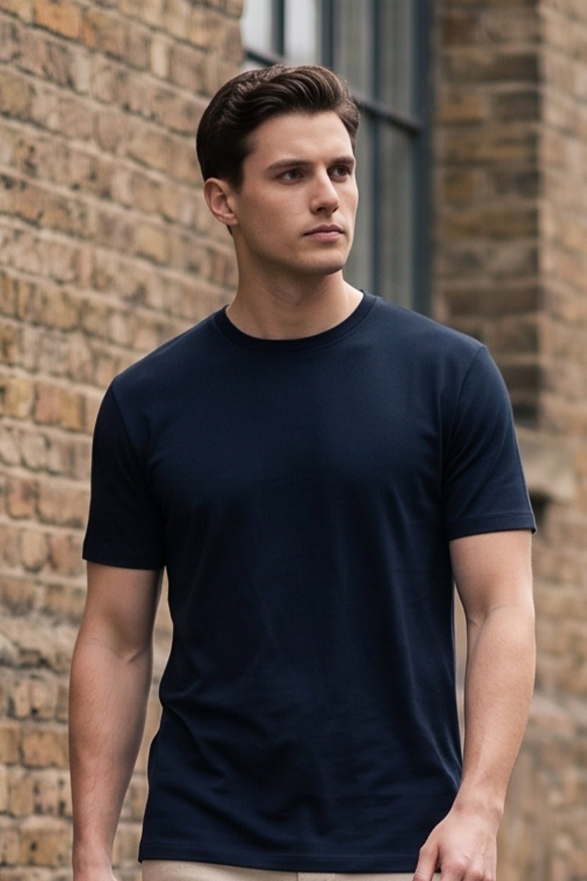 Man wearing a navy wholesale cotton blend crewneck t-shirt from S&S Textile and Apparel Inc., city street lifestyle photo, mobile view
